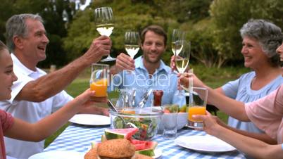 Cheerful family clinking glasses