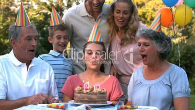 Happy family celebrating a birthday and clapping hands