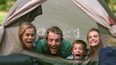 Happy family having fun together in a tent