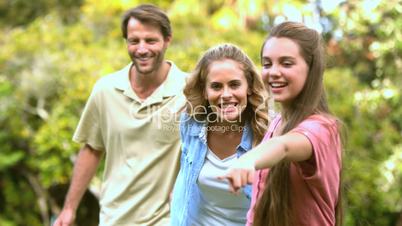 Little girl pointing something to her parents