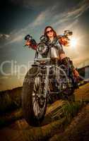 Biker girl sitting on motorcycle