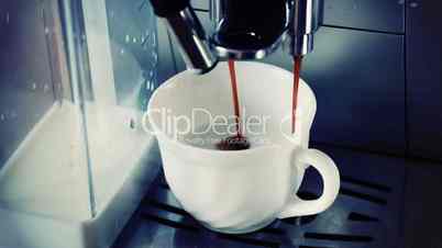 coffee machine pouring cappuccino in cup