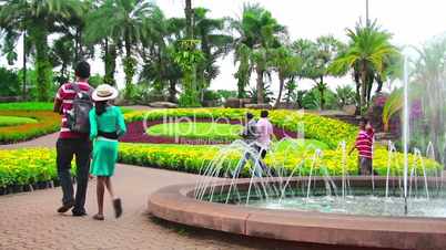 people walks in famous Nong Nooch tropical garden