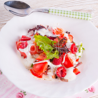 salad with dressing and fresh raspberry