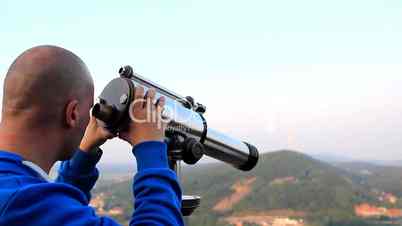 Male - watching environment with telescope - blue cardigan
