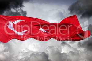 waving flag of turkey against storm clouds