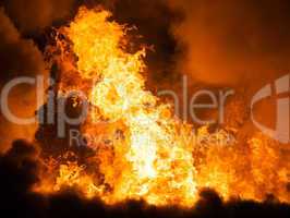 burning fire flame on wooden house roof