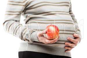 pregnant woman hand holding red raw ripe apple fruit
