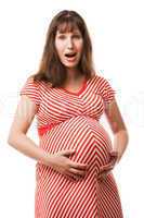 Amazed or surprised pregnant woman touching or bonding her abdom