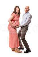 Amazed or surprised parents holding pregnant woman abdomen