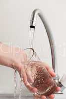 hand washing dish or pouring glass with drink water