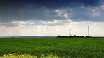 green field and cloudy sky