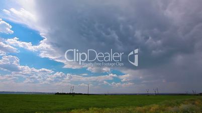 green field and cloudy sky