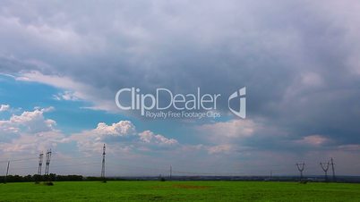 green field and cloudy sky