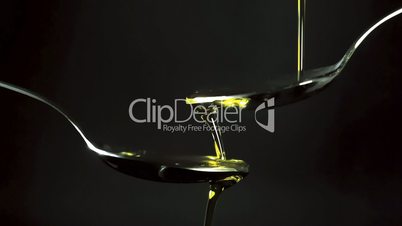 pouring olive oil in a tablespoons