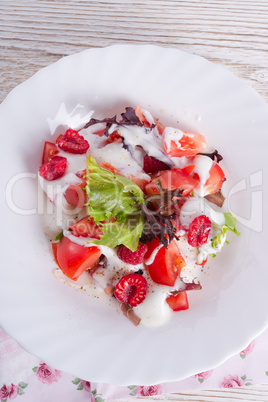 salad with dressing and fresh raspberry