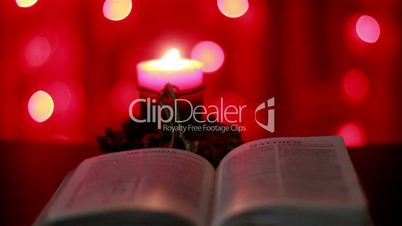 Christmas candle and opened Bible
