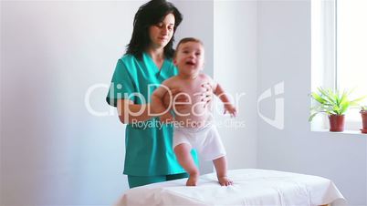 Nurse playing with a baby in hospital
