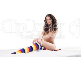 Smiling naked brunette posing in colorful socks