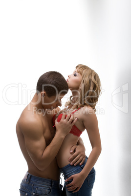 Athletic man hugging shapely woman