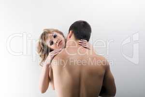 Muscular man kissing young attractive girl
