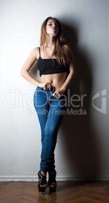 Image of sensual slim woman taking off jeans