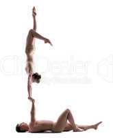 Pair of young acrobats training in studio