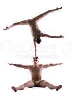 Athletic people showing acrobatic trick in studio
