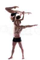Couple of young graceful acrobats posing in studio