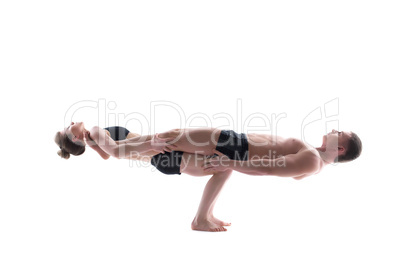 Couple of flexible gymnasts balancing in studio