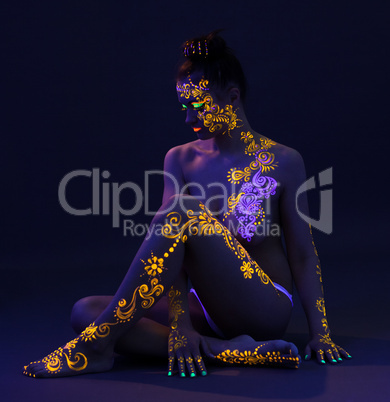 Graceful woman with glowing pattern on body