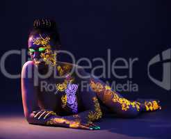 Attractive naked girl with UV makeup in studio
