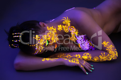Portrait of beautiful woman with UV makeup