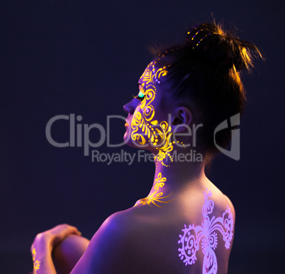 Profile of brunette with glowing disco makeup