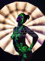 Pretty girl with disco ultraviolet makeup dancing