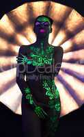 Image of naked disco dancer with UV glowing makeup