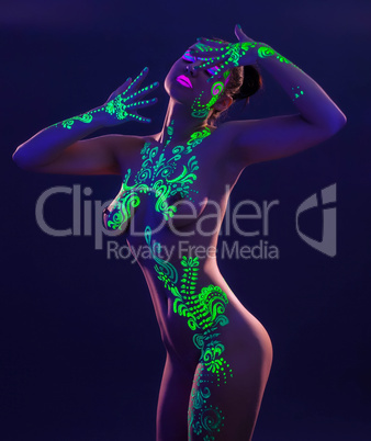 Slim model posing with glowing pattern on body
