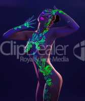 Slim model posing with glowing pattern on body