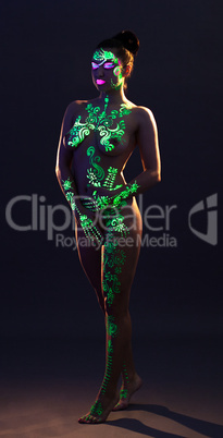 Naked woman posing with glowing pattern on body