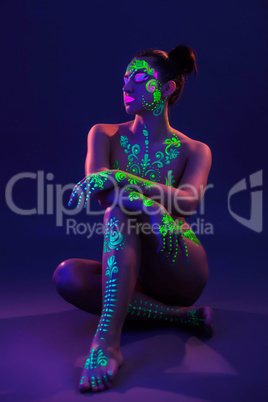 Attractive girl posing with colorful UV makeup