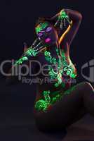 Portrait of slim naked woman with UV makeup