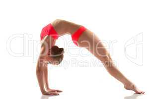Slim flexible woman doing gymnastics bridge