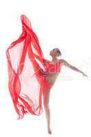 Attractive gymnast dancing with cloth in studio