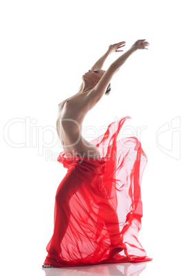 Young topless woman dancing with cloth in studio