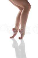 Slender nude female legs isolated on white