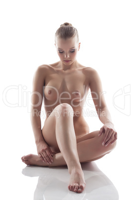 Image of young woman posing nude in studio