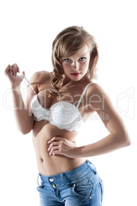 Portrait of sexy woman posing in bra and jeans