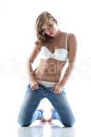 Beautiful slim girl posing taking off jeans