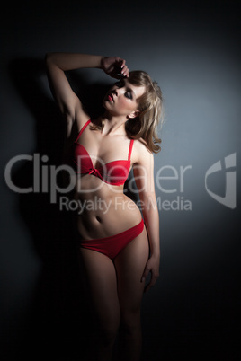 Sexual slim model posing in red lingerie