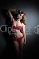 Sexual slim model posing in red lingerie